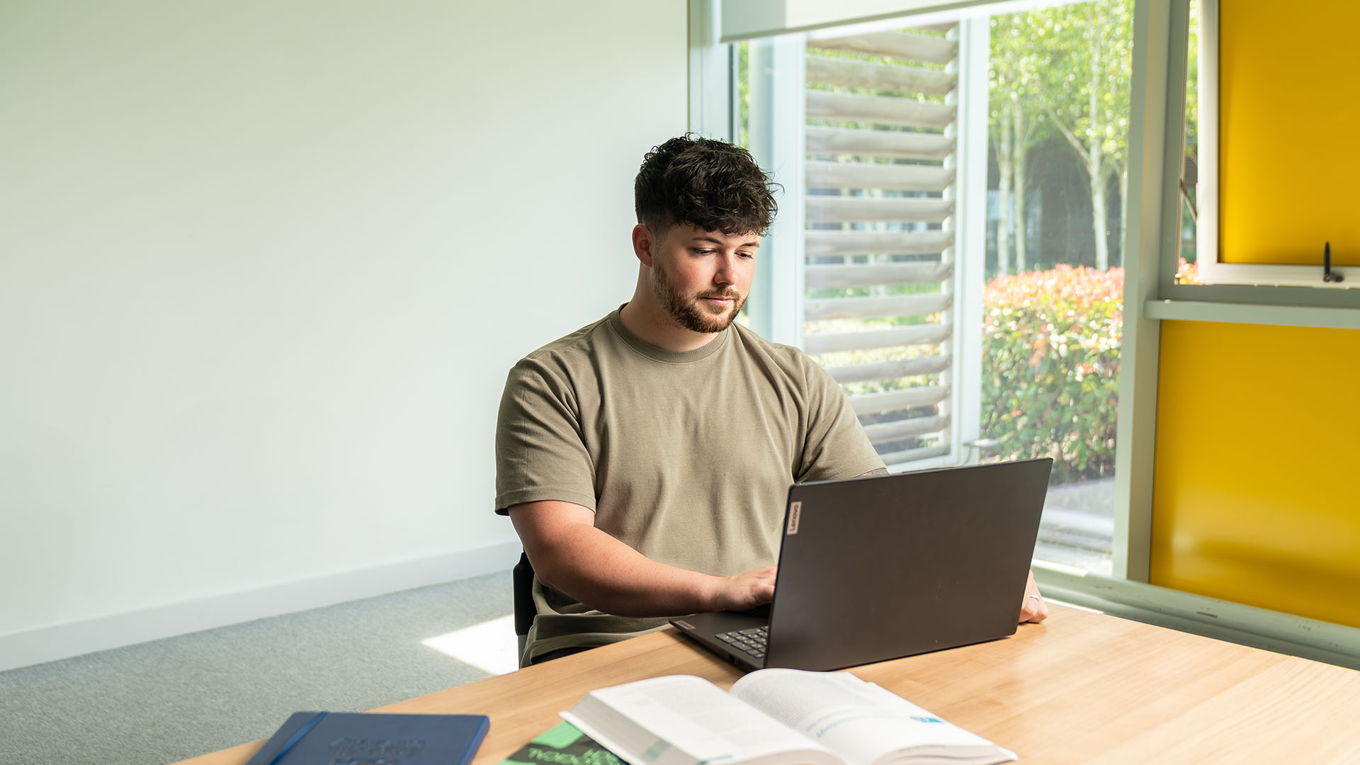 Criminology student working at a laptop.