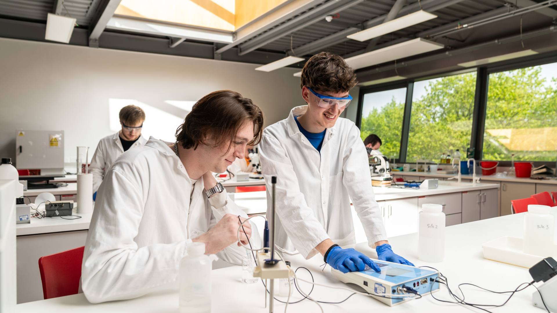 Two students in a lab, working on a geology project.