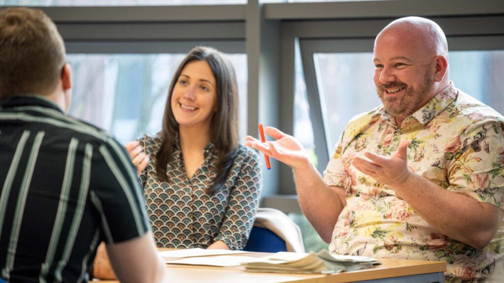 People talking at a post graduate event