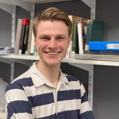 Danny Bowman, looking at the camera smiling - wearing a stripy blue and white jumper. 