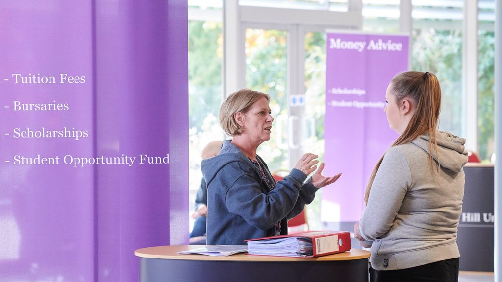 Member of Money Advice Team discussing options with prospective student at event