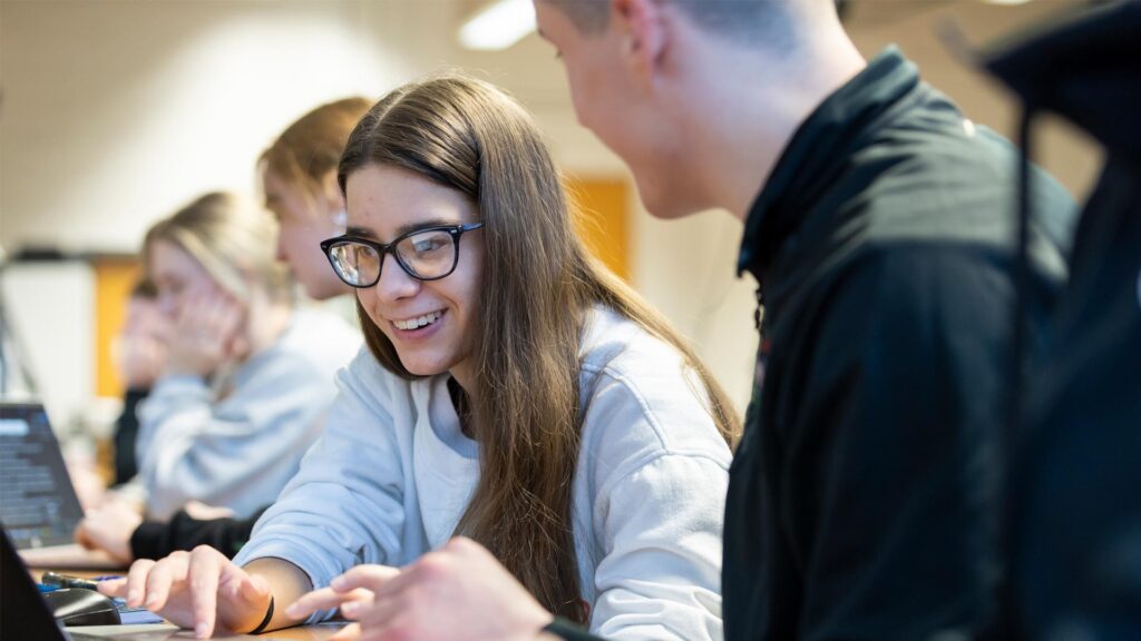 Student typing on computer